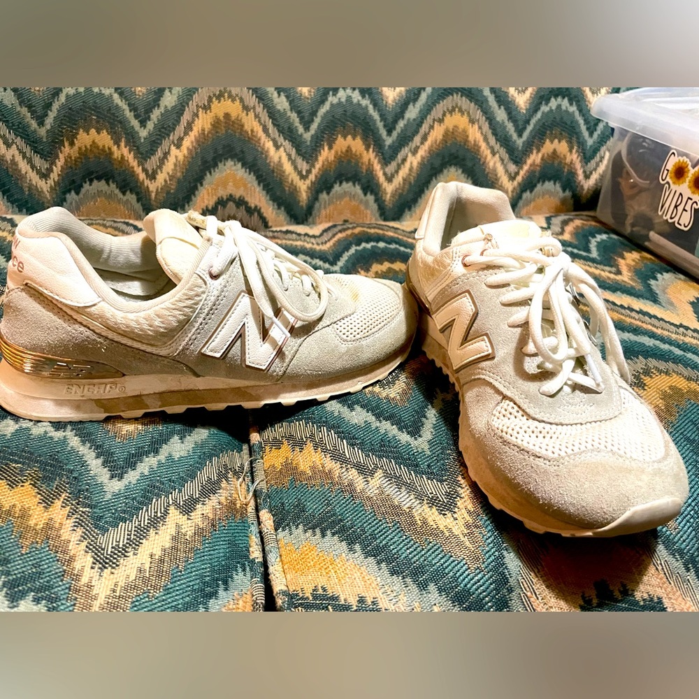 White and gold woman’s New Balance shoes